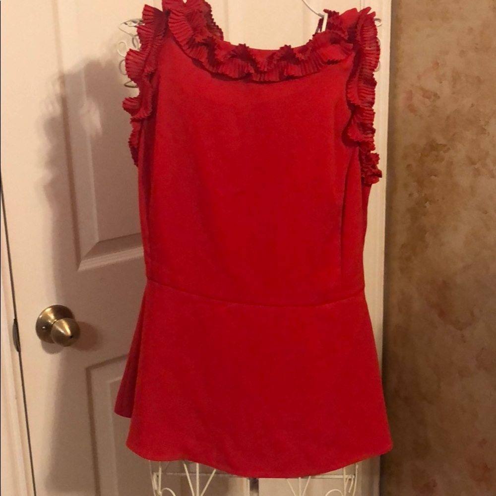 Women’s sleeveless blouse with ruffle accents